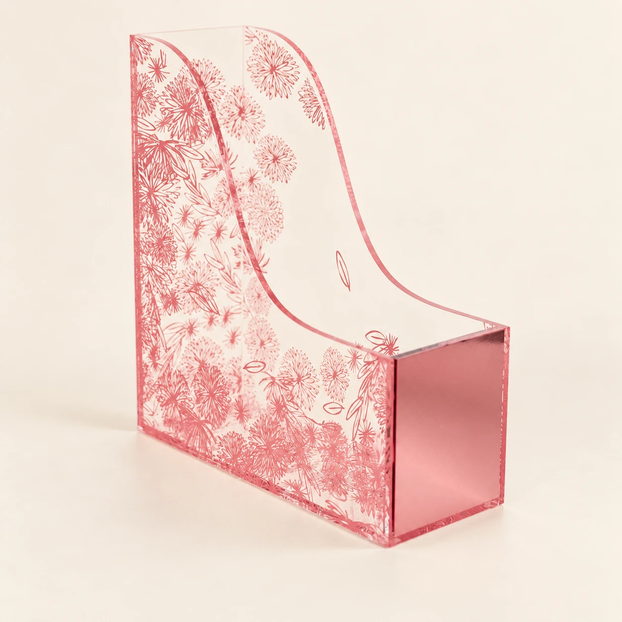 Clear acrylic magazine holder with curved sides and monochromatic pink floral linework on a warm ivory background.